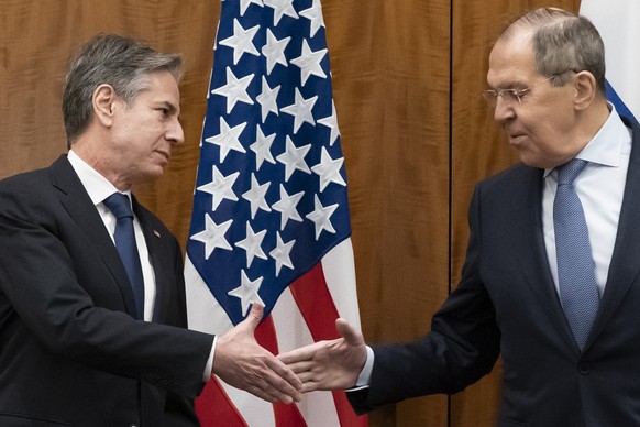 FILE - Secretary of State Antony Blinken, left, greets Russian Foreign Minister Sergey Lavrov before their meeting, Friday, Jan. 21, 2022, in Geneva, Switzerland. With tens of thousands of Russian tro ...