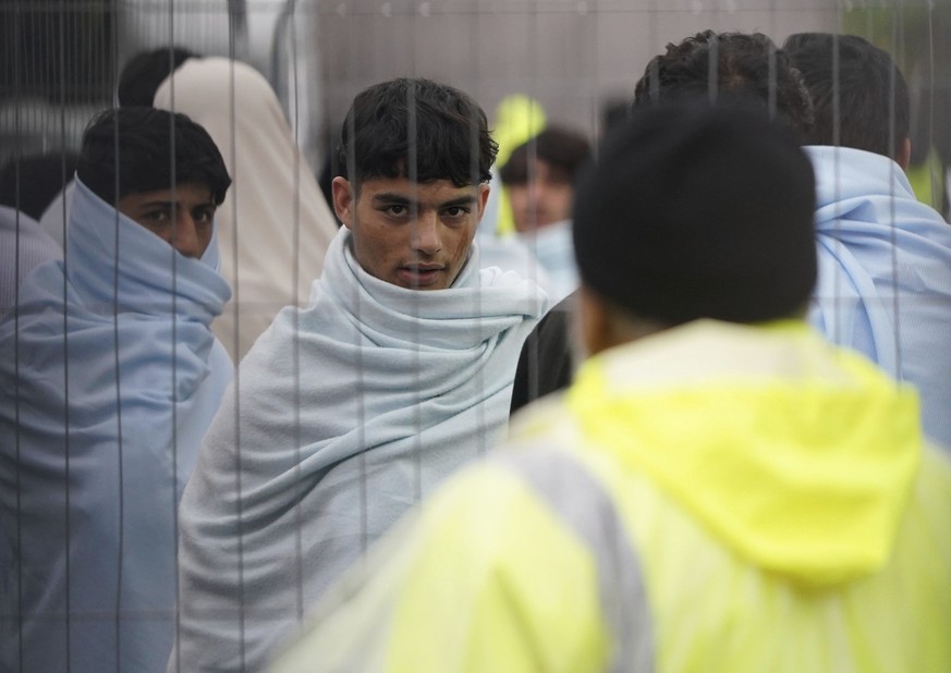 A view of people thought to be migrants inside the Manston immigration short-term holding facility located at the former Defence Fire Training and Development Centre in Thanet, Kent, England, Thursday ...