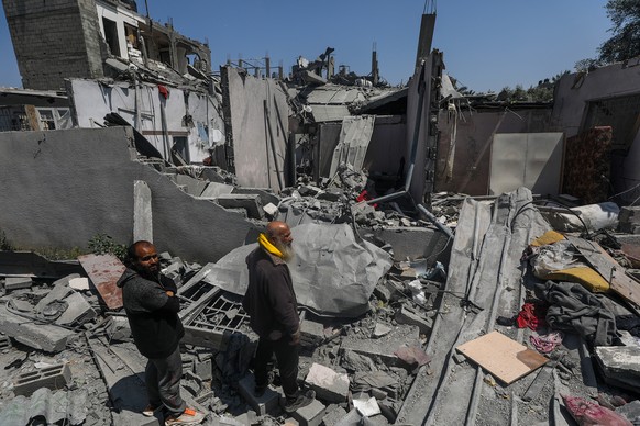 epa11280115 Palestinians inspect their destroyed houses in Al Maghazi refugee camp, central Gaza Strip, 15 April 2024, following Israeli air strikes. More than 33,700 Palestinians and over 1,450 Israe ...