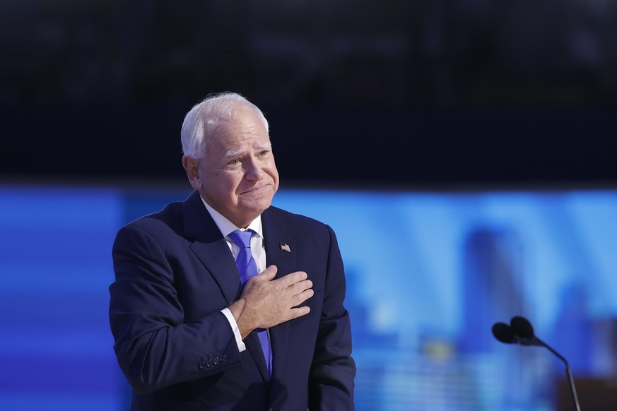 epa11559267 Democratic Vice Presidential nominee Tim Walz reacts to the audience during the third night of the Democratic National Convention (DNC) at the United Center in Chicago, Illinois, USA, 21 A ...
