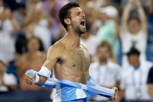 MASON, OHIO - AUGUST 20: Novak Djokovic of Serbia tears his shirt off after defeating Carlos Alcaraz of Spain during the final of the Western &amp; Southern Open at Lindner Family Tennis Center on Aug ...