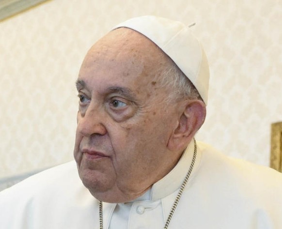epa11654695 A handout picture provided by the Vatican Media shows Pope Francis (R) and Ukrainian President Volodymyr Zelensky (L) exchanging gifts during a private audience in the Vatican City, 11 Oct ...