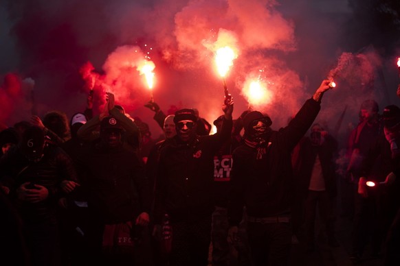 Toronto FC fans hold flares as they walk to BMO field for their team's MLS Eastern Conference semifinal match against the New York Red Bulls in Toronto, Sunday, Nov. 5, 2017. (Chris Young/The Canadian ...