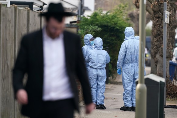 Forensic experts get ready to investigate the area in Golders Green, London, Monday, March 23, 2026 after an arson attack on four vehicles belonging to a Jewish ambulance service, Hatzola Northwest.(A ...