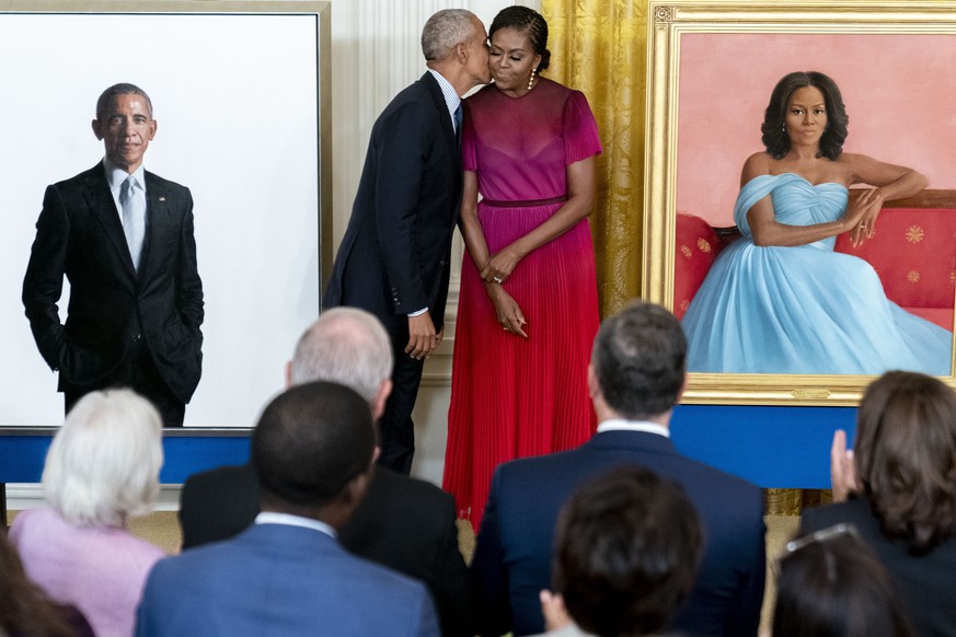 Former President Barack Obama kisses his wife former first lady Michelle Obama after they unveiled their official White House portraits during a ceremony in the East Room of the White House, Wednesday ...