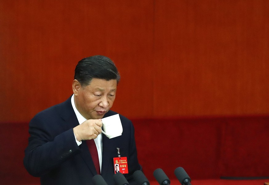 epa10246580 Chinese President Xi Jinping drinks from a cup during the opening ceremony of the 20th National Congress of the Communist Party of China at the Great Hall of People in Beijing, China, 16 O ...