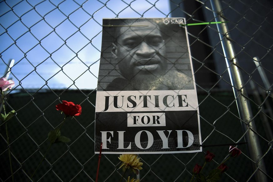 epa09062374 Protesters placed flowers and posters on the fence that surrounds the Hennepin County Government Center as jury selection was to begin in the trial of former officer Derek Chauvin in the k ...