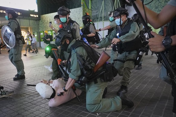 Hong Kong Riot police detain a protester during a protest in Causeway Bay, Hong Kong, Friday, June 12, 2020. Protesters in Hong Kong got its government to withdraw extradition legislation last year, b ...