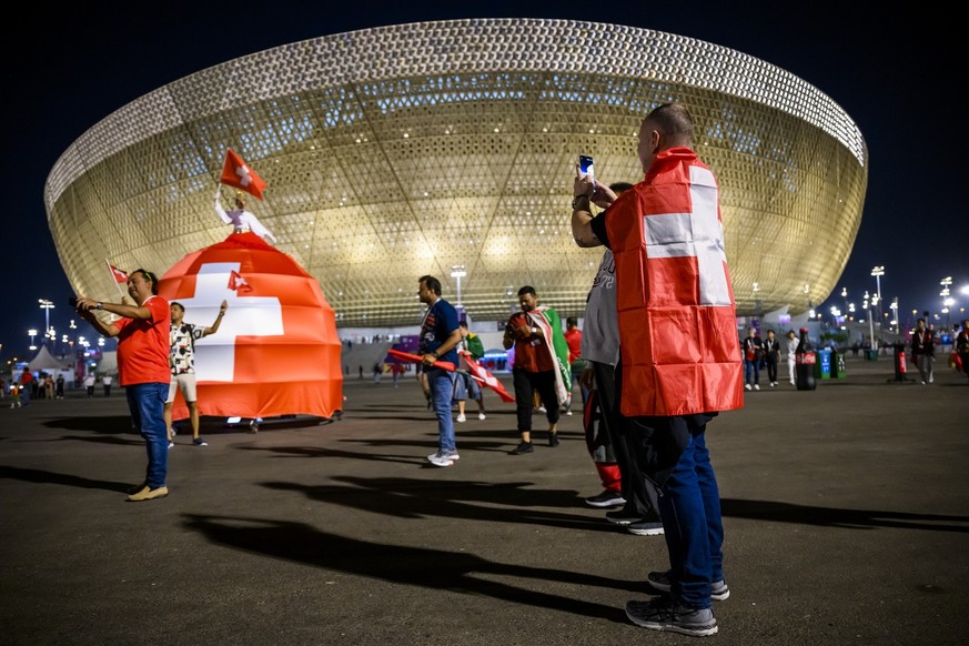 Swiss fans celebrate front of the stadium during the FIFA World Cup Qatar 2022 round of 16 soccer match between Portugal and Switzerland at the Lusail Stadium in Lusail, north of Doha, Qatar, Tuesday, ...