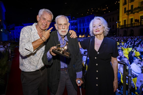 KEYPIX - Actor Jean-Luc Bideau of Switzerland prize winner of the "Lifetime Achievement Award" poses with with his son Nicolas Bideau and his wife Marcela Salivarova Bideau front of the Piaz ...
