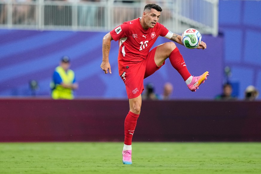 Switzerland's Granit Xhaka jumps to control the ball during the World Cup quarterfinal soccer match against Argentina in Kansas City, Mo., Saturday, July 11, 2026. (AP Photo/Charlie Riedel)
Grani ...