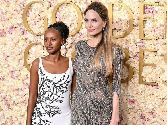 BEVERLY HILLS, CALIFORNIA - JANUARY 05: Zahara Jolie and Angelina Jolie attend the 82nd Annual Golden Globe Awards at The Beverly Hilton on January 05, 2025 in Beverly Hills, California. (Photo by Axe ...