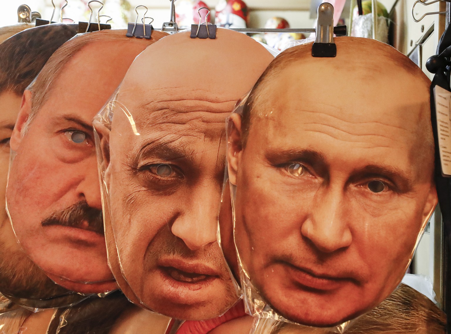 epa10715384 (L-R) Face masks depicting Belarus President Alexander Lukashenko, owner of PMC (Private Military Company) Wagner Yevgeny Prigozhin and Russian President Vladimir Putin are displayed for s ...