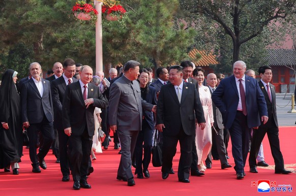 In this photo provided by the North Korean government, from left in front, Russian President Vladimir Putin, Chinese President Xi Jinping and North Korean leader Kim Jong Un walk to attend a military  ...