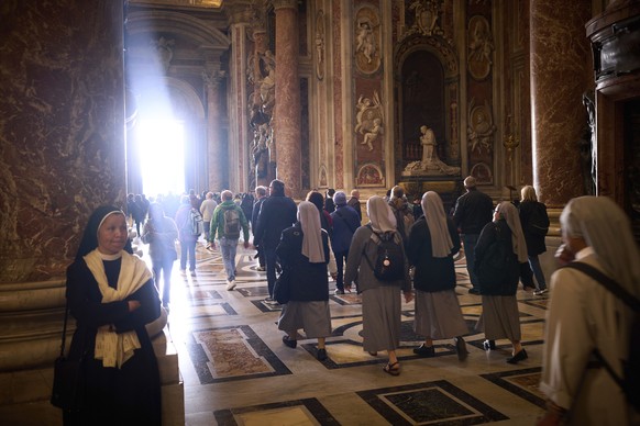 People walk at St. Peter&#039;s Basilica where Pope Francis lying in state, at the Vatican, Friday, April 25, 2025. (AP Photo/Emilio Morenatti)
Vatican Pope