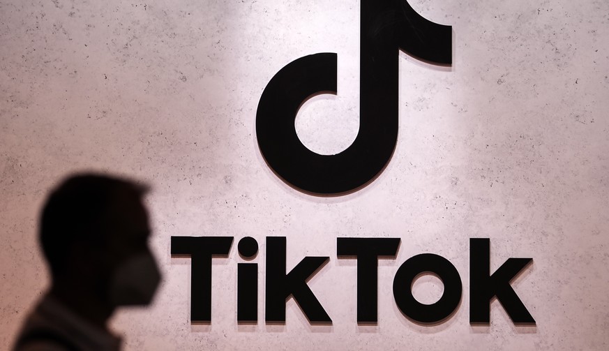 FILE - A visitor passes the TikTok exhibition stands at the Gamescom computer gaming fair in Cologne, Germany, Aug. 25, 2022. The European Union&#039;s digital policy chief warned TikTok&#039;s boss T ...