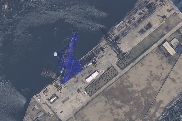 This satellite image provided by Airbus DS, shows a blue tarp covering a North Korean destroyer after it suffered a failed launch while it was being put to sea in Chongjin, North Korea, Thursday, May  ...