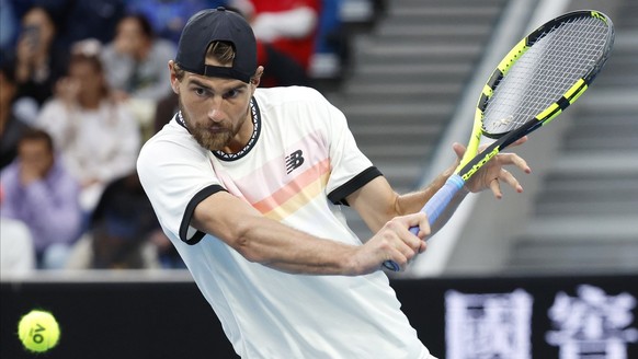 Maxime Cressy of the U.S. plays a backhand return to Holger Rune of Denmark during their second round match at the Australian Open tennis championship in Melbourne, Australia, Thursday, Jan. 19, 2023. ...