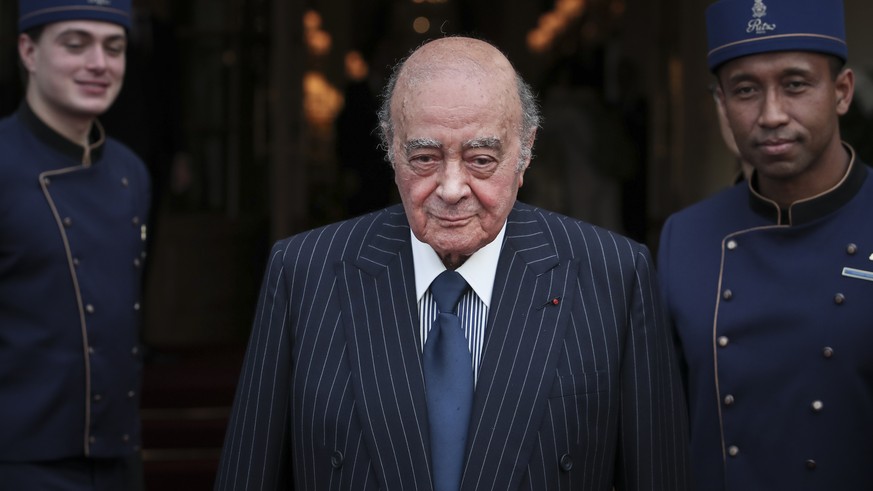 FILE - Egyptian businessman and Ritz hotel owner Mohammed Al Fayed poses with his hotel staff in Paris, Monday, June 27, 2016. (AP Photo/Kamil Zihnioglu, File)