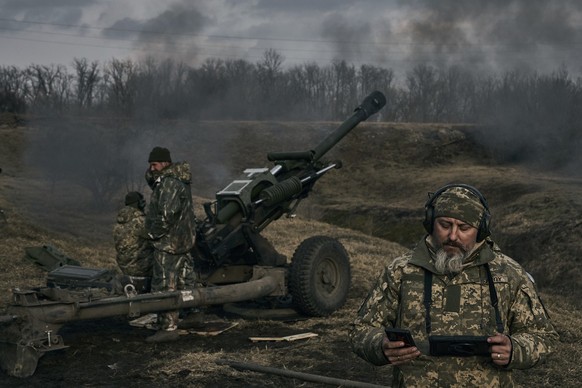 Ukrainian soldiers fire a self-propelled howitzer towards Russian positions near Bakhmut, the site of the heaviest battles, Donetsk region, Ukraine, Tuesday, March 7, 2023. (AP Photo/Libkos)