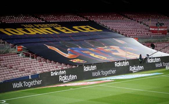 epa09077041 A general view of the Camp Nou stadium with a giant placard that shows Argentinian striker Lionel Messi (R) and Spanish soccer legend Xavi Hernandez (L) on occasion of Messi reaching the s ...