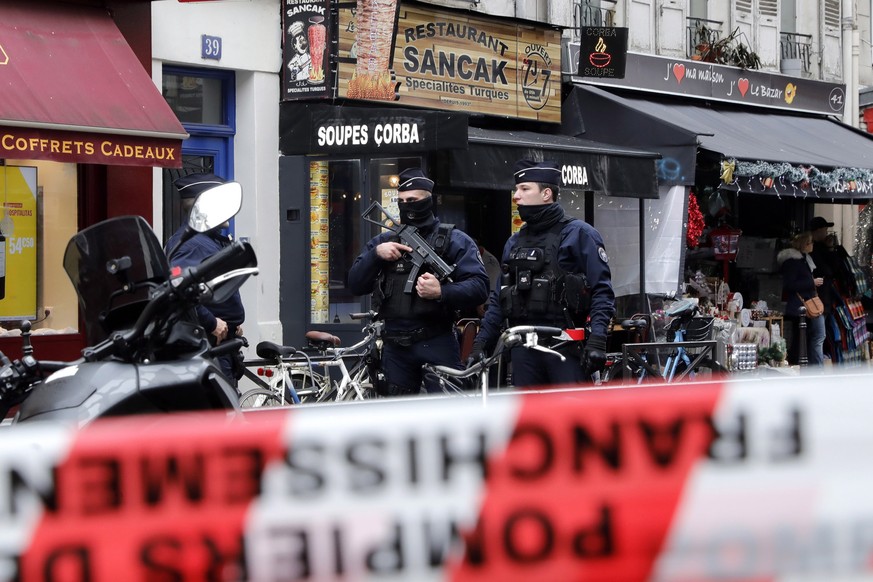 epa10377080 Armed police officers secure the perimeter on &#039;Rue d&#039;Enghien&#039; following a shooting incident near a Kurdish cultural centre in Paris, France, 23 December 2022. The Paris Poli ...