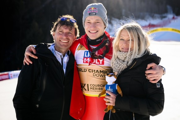 Gold medalist Marco Odermatt of Switzerland celebrates with father Walter and mother Priska during the podium ceremony of the men&#039;s downhill race at the 2023 FIS Alpine Skiing World Championships ...