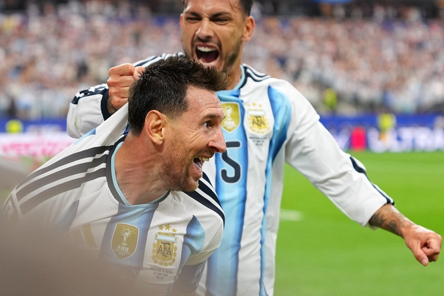 Argentina's Lionel Messi, left, celebrates with Leandro Paredes after scoring his side's second goal during the World Cup Group J soccer match between Argentina and Austria in Arlington, Tex ...