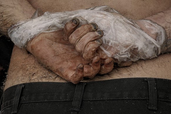 FILE - A lifeless body of a man with his hands tied behind his back lies on the pavement in Bucha, Ukraine, Sunday, April 3, 2022. Associated Press journalists in Bucha, a small city northwest of Kyiv ...