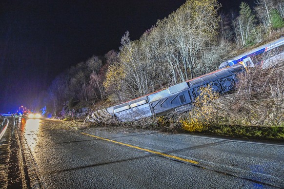 epa11680744 A view of the wrecked train wagons at the site of a derailment in Finneidfjord, Nordland municipality, Norway, on 24 October 2024. According to police, at least one person died and several ...