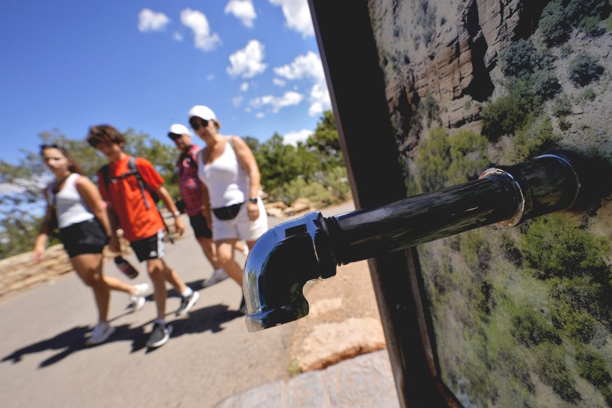 A group of day visitors walk past a closed water bottle tap along the Rim Trail, as visitors won&#039;t be able to stay overnight in hotels or refill water bottles at Grand Canyon National Park after  ...