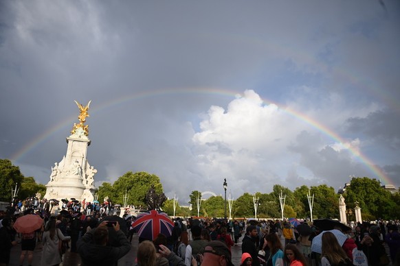 epa10170339 A rainbow appears above the Queen Victoria Memorial as people gather in front of Buckingham Palace in London, Britain, 08 September 2022. According to a Buckingham Palace statement on 08 S ...