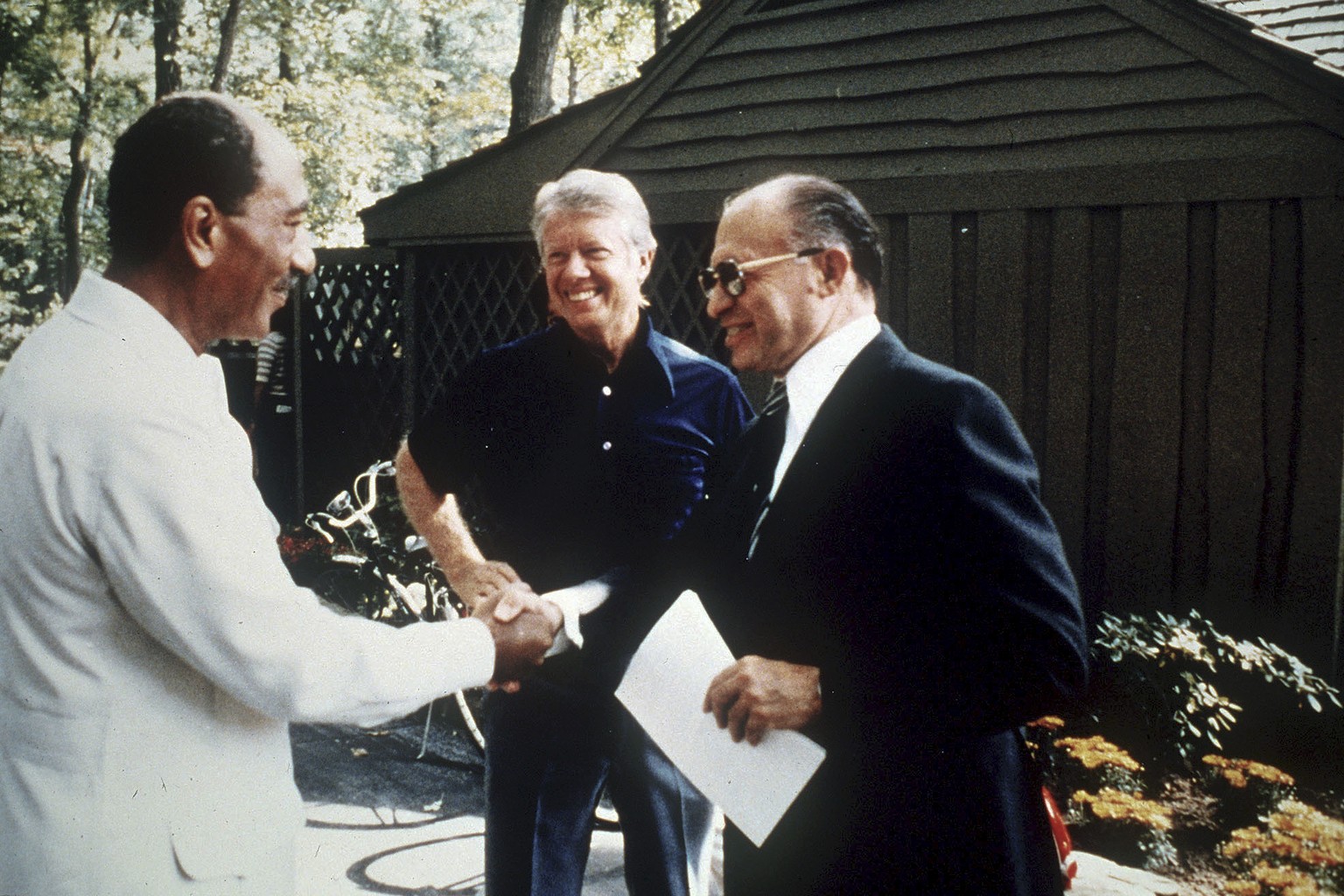 FILE - Egypt&#039;s President Anwar Sadat, left, shakes hands with Israeli Prime Minister Menachem Begin as U.S. President Jimmy Carter, center, looks on at Camp David, Md., Sept. 7, 1978. (AP Photo,  ...
