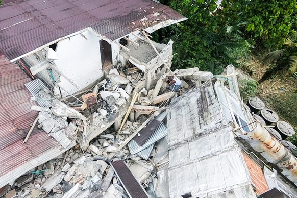 epa13159880 An aerial photograph showing civilians searching through the rubble of a building destroyed after a powerful earthquake in Quibdo, Colombia, 10 August 2026. A 7.4-magnitude earthquake shoo ...