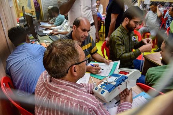 June 4, 2024, Srinagar, India: Electoral officials tally votes from an Electronic Voting Machine EVM at a polling counting centre in Srinagar. India began counting more than 640 million votes Tuesday  ...