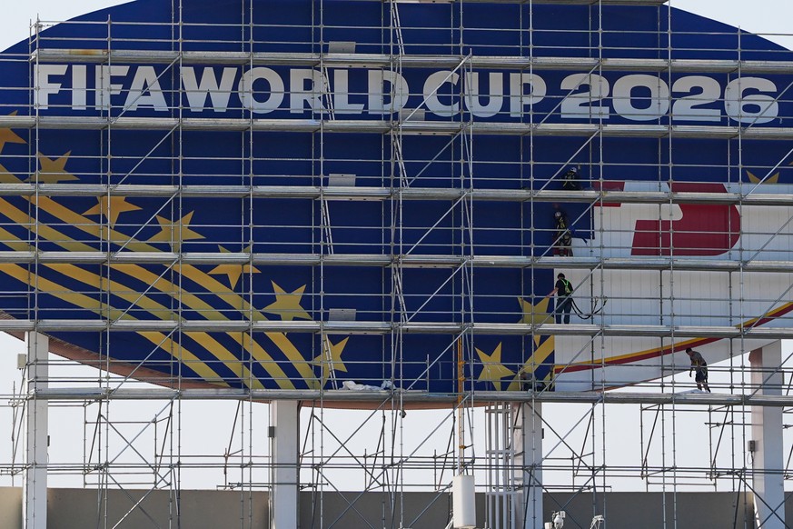 Workers cover a Kansas City Chiefs sign to FIFA World Cup 2026 as work continues to transform Arrowhead Stadium to Kansas City Stadium ahead of the FIFA World Cup soccer tournament Monday, June 8, 202 ...