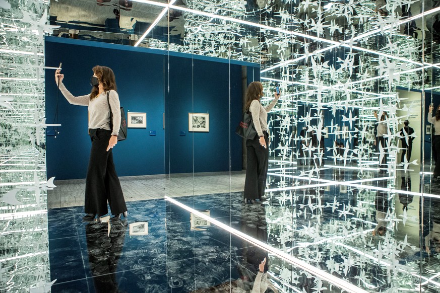 epa09165183 A visitor poses inside an installation by Dutch artist Maurits Cornelis Escher on the opening day of an exhibition devoted to Escher at the Gothic Atarazanas Center in Barcelona, Spain, 28 ...