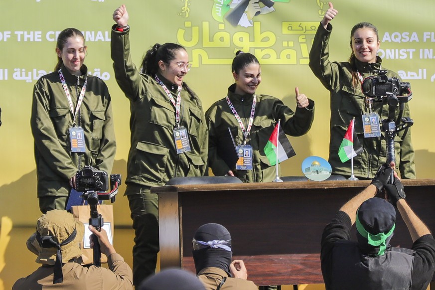 Israeli female soldier hostages Naama Levy, Daniella Gilboa, Karina Ariev and Liri Albag, in no particular order, salute a iPalestinian crowd before being handed over to the Red Cross in Gaza City, Sa ...