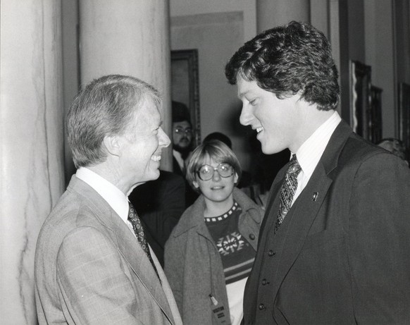 epa11798059 (FILE) A handout photo made available by the Jimmy Carter Library shows US President Jimmy Carter (L) meeting with Arkansas Governor-elect Bill Clinton at The White House in Washington, DC ...