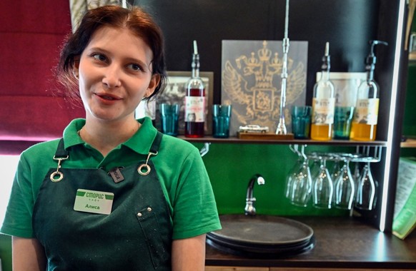 Alisa, a 20-year-old waitress, works in a cafe in a small Russian town of Vereya, 100 kilometres southwest form Moscow on April 15, 2025. (Photo by Alexander NEMENOV / AFP)