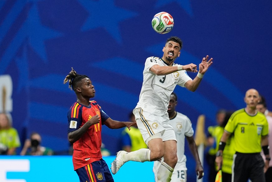 Saudi Arabia's Ali Lajami heads the ball next to Spain's Nico Williams during the World Cup Group H soccer match between Spain and Saudi Arabia in Atlanta, Sunday, June 21, 2026. (AP Photo/M ...