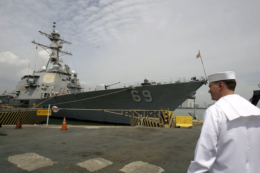 An American sailor walks in front of the USS Milius (DDG 69), an Arleigh Burke class guided missile destroyer, as it docks at Manila&#039;s south harbor, Philippines on Saturday, Aug. 18, 2012. The U. ...