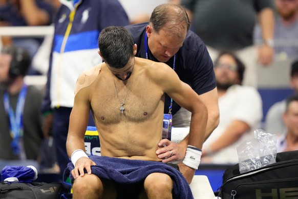 Novak Djokovic, of Serbia, gets medical treatment during the first round of the U.S. Open tennis championships against Mariano Navone, of Argentina, Sunday, Aug. 30, 2026, in New York. (AP Photo/Frank ...
