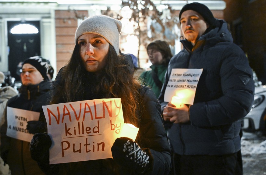 People attend a vigil for Alexei Navalny outside the Russian consulate in Montreal, Friday, Feb. 16, 2024. Alexei Navalny, who crusaded against official corruption and staged massive anti-Kremlin prot ...