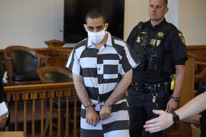 Hadi Matar, 24, center, arrives for an arraignment in the Chautauqua County Courthouse in Mayville, N.Y., Saturday, Aug. 13, 2022. Matar, who is accused of carrying out a stabbing attack against �??Sa ...