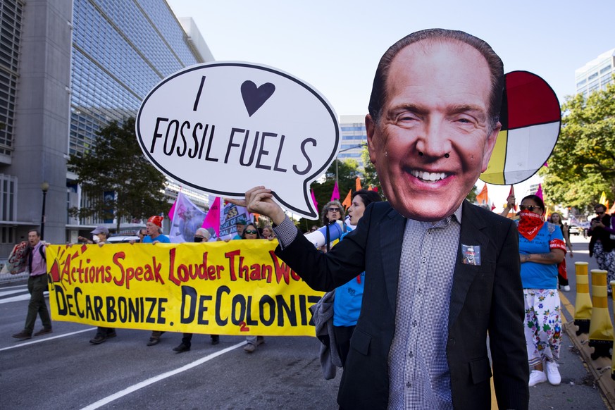 epa10244061 A person dressed as World Bank Group President David Malpass joins protesters as they march outside the World Bank and IMF during the 2022 Annual Meetings of the IMF and World Bank Group ( ...