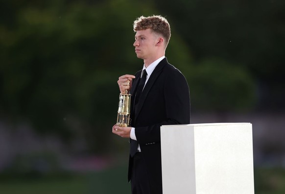 PARIS, FRANCE - AUGUST 11: Leon Marchand of Team France carries the Olympic flame during the Closing Ceremony of the Olympic Games Paris 2024 at Stade de France on August 11, 2024 in Paris, France. (P ...