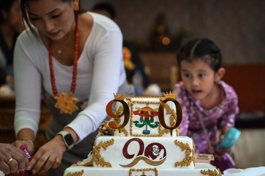 Tibetans in exile distribute cake as they celebrate the 90th birthday of the Tibetan spiritual leader, the Dalai Lama, in New Delhi on July 6, 2025. Calling himself a &quot;simple Buddhist monk&quot;  ...