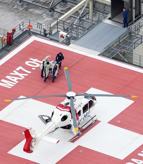 A patient, believed to be Japan���s former Prime Minister Shinzo Abe, is carried on a stretcher on arrival by medical helicopter at a hospital in Kashihara, Nara prefecture, western Japan Friday, July ...