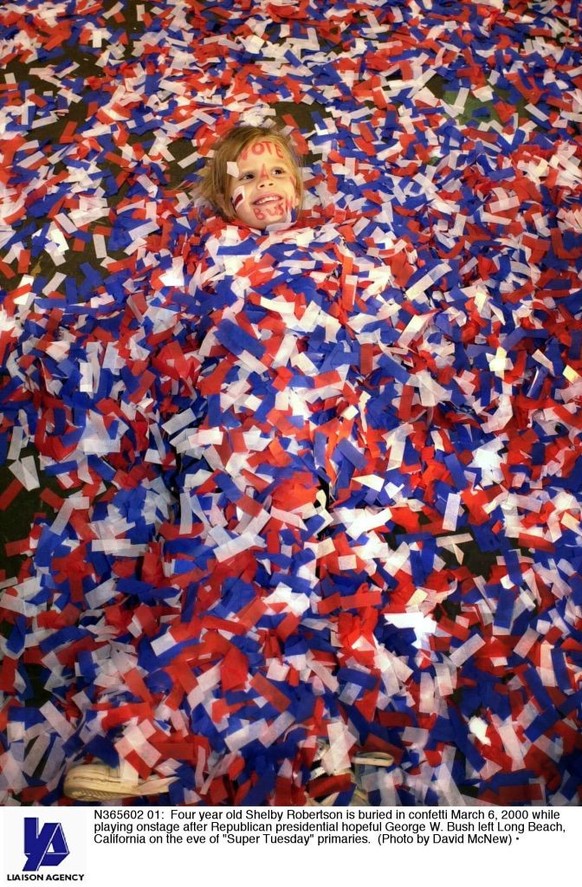 N365602 01: Four year old Shelby Robertson is buried in confetti March 6, 2000 while playing onstage after Republican presidential hopeful George W. Bush left Long Beach, California on the eve of &quo ...